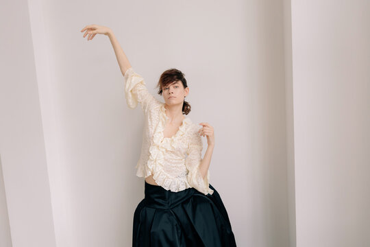 Sculptural editorial pose in ivory lace and dark silhouette