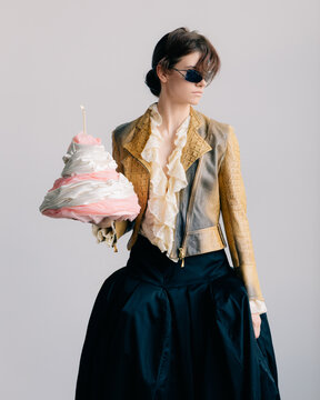 Avant-garde fashion portrait with sculptural pastel object cake