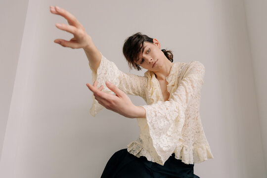 Avant-garde fashion portrait with expressive hand movement