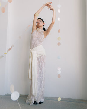 Full length fashion portrait of woman in sheer elegant dress