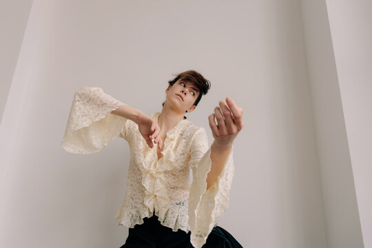Theatrical editorial portrait with sculptural hand choreography
