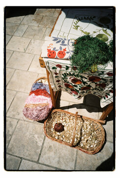 Craft materials and silkworm cocoons on outdoor market table