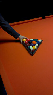Setting up a game of pool with a rack of balls
