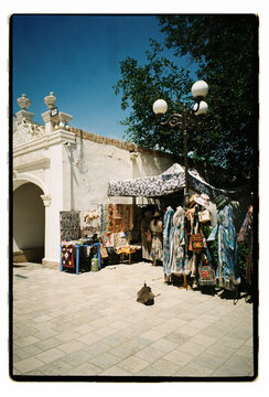 Traditional crafts and fabrics hanging in a historic marketplace
