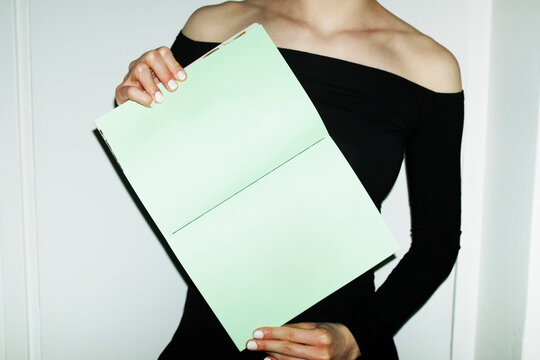 Person holding colourful mockup paper book with empty space for text