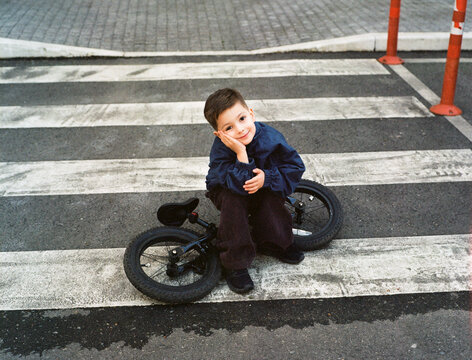 Todder Is Sitting On His Bike Outside
