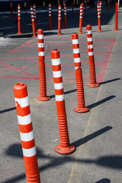 Plastic bollards are standing around in the street
