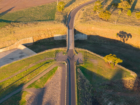 Road and bridge over a deep cut away reservoir spillway