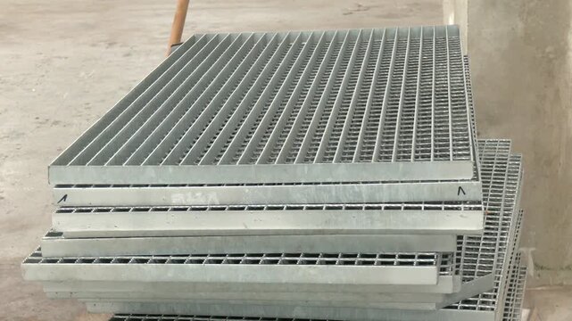 Detail of grate steel floor. A close-up of an industrial metal grating, showcasing a repetitive grid pattern and cool, gray tones, conveying concepts of urban environments, modern design
