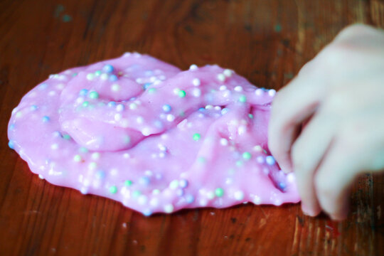 Pink and purple crunchy slime with foam balls close up