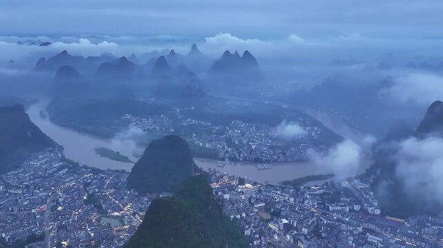 Misty aerial dawn over Yangshuo karst mountains and winding river, Guangxi, China in Yangshuo, Guangxi, China