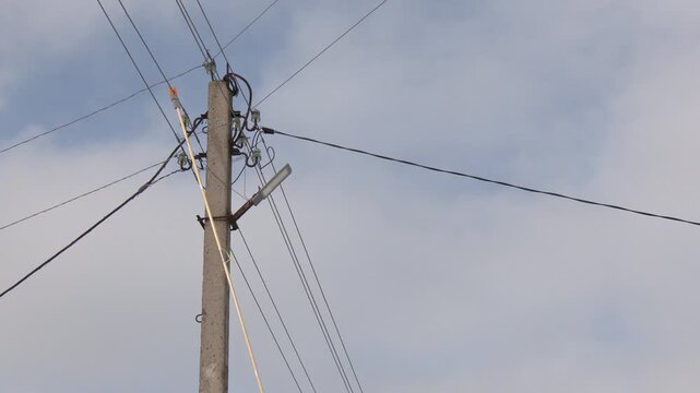 Measurement of electrical parameters using a digital multimeter in an electrical panel. The power lineman must be trained because it is a risky job