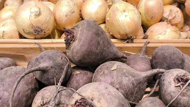 Market stall with beets and onions. Fresh farm vegetables display