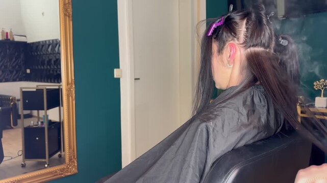 Beauty Salon Hair Straightening Procedure with Professional Stylist. High quality FullHD footage