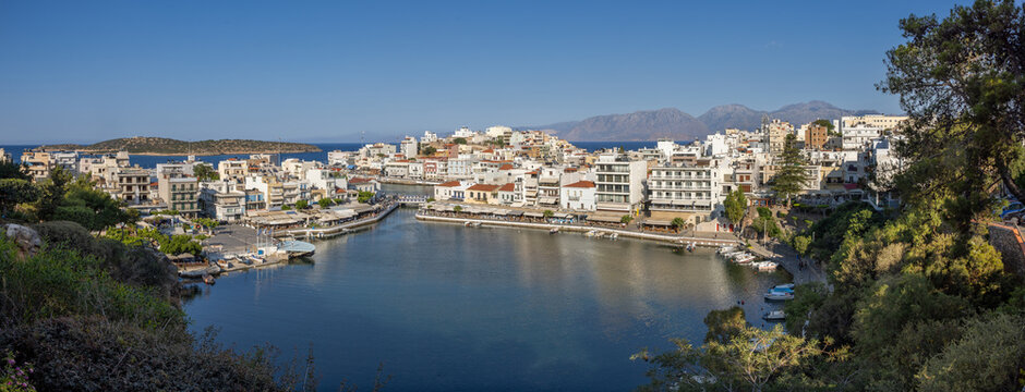 Agios Nikolaos on the island Crete, Greece, with Lake Voulismeni. Unidentifiable People in the distance