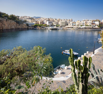 Agios Nikolaos on the island Crete, Greece, with Lake Voulismeni. Unidentifiable People in the distance