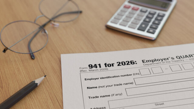 IRS Form 941 on table with glasses, calculator, and pencil