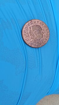 Vintage Mexican 5 Centavos Coin from 1978 on Vibrant Blue Background