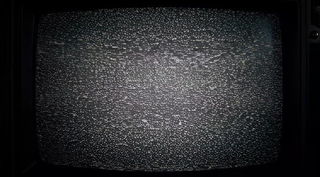 Old television screen showing static noise with no signal on a dark background