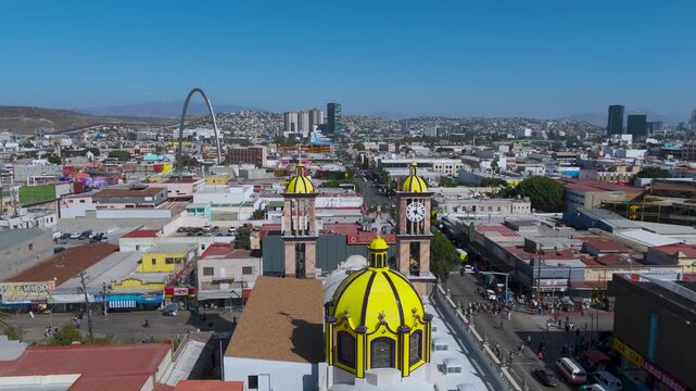 Aerial Tracking Shot of Cathedral Domes and Main Avenue Leading Toward US-Mexico Border in Tijuana, Mexico.