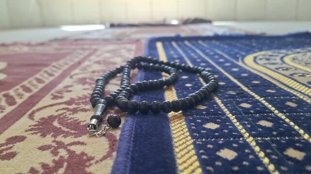 Prayer beads resting on a prayer mat in a mosque