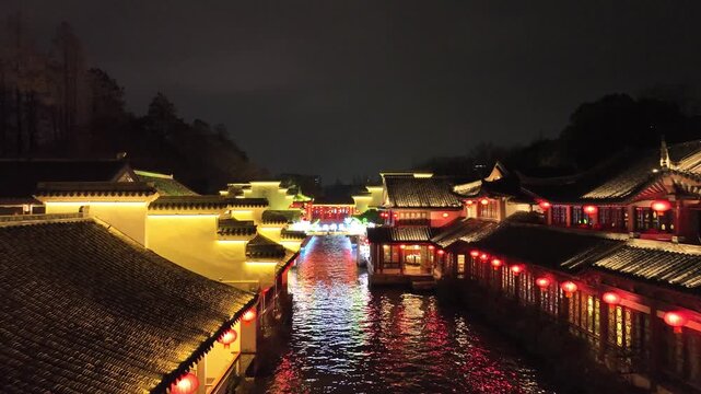 Traditional Chinese Water Town at Night with Red Lanterns Along Canal
