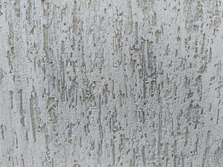 Fototapeta premium Rough textured stucco wall background with vertical grooves. Abstract grey plaster facade pattern.