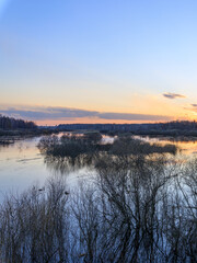 Obraz premium Soft sunset reflects on calm river surface