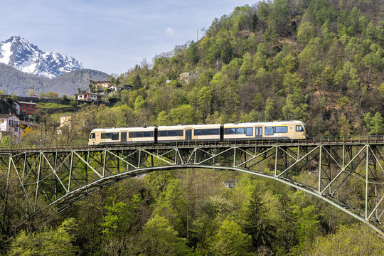 Commuter train by Stadler Rail on Domodossola&ndash;Locarno railway line on Isorno bridge in Intragna, Switzerland