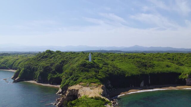 石川県 加佐の岬と周辺の自然地形を見下ろす高高度空撮 後退・右パン / High altitude aerial drone pulling back and panning right over the natural terrain of Cape Kasa and Sea of Japan