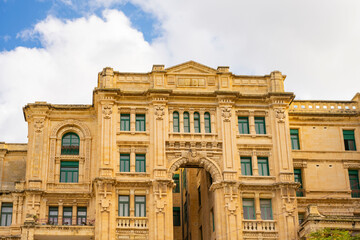 Fototapeta premium This scene depicts Balluta Bay in St. Julian's, Malta, featuring a beach promenade.The large Neo-Gothic building is the Carmelite Church (Parish Church of Our Lady of Mount Carmel).The bay is a popula