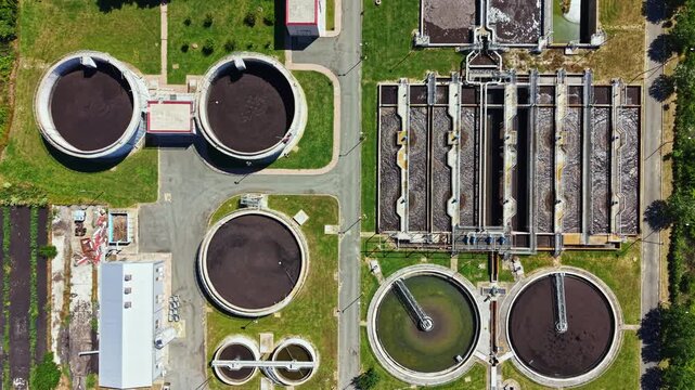 A water treatment facility with various circular tanks and processing areas. The layout reveals workspaces and machinery for water purification.