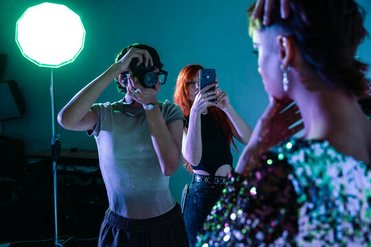 Behind the scenes fashion photo shoot with camera and phone