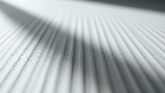 Abstract textured surface with diagonal light and shadow.