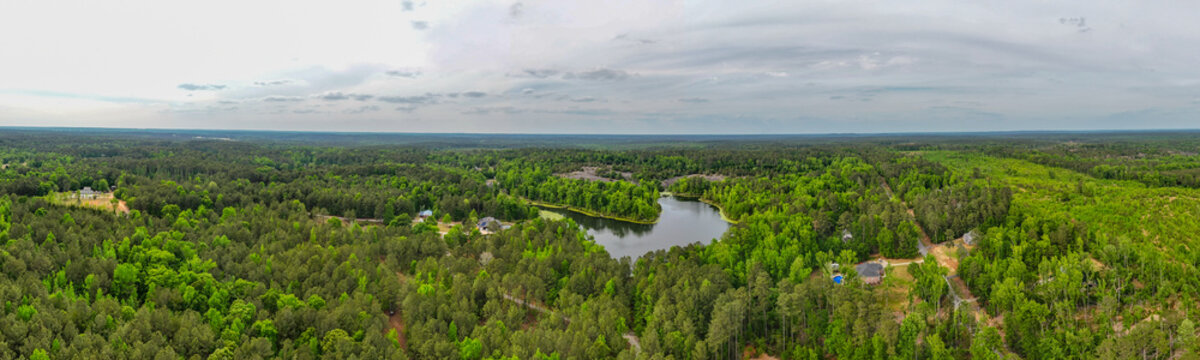 Wide aerial drone panorama of rural forest landscape and cloudy sky in Georgia, USA
