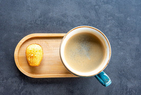 Black coffee with madeleine biscuit