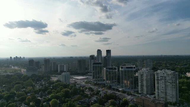 Aerial over Bloor Street West in Kingsway, Toronto, Ontario, Canada. Skyline of high-rises around Islington Station and the Islington City-Centre West neighborhood. Tilting down.
