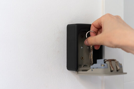 Taking apartment keys from open lockbox during contactless check in at rental home