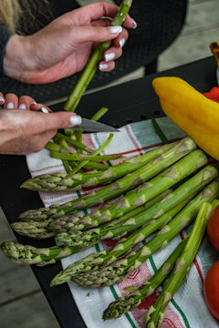 Peeling fresh asparagus preparation closeup
