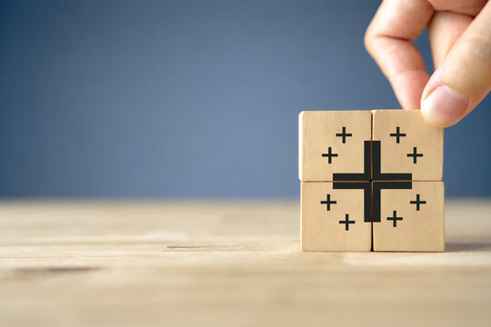 Positive things; added value, benefits, additional, personal development, growth mindset, positive thinking, opportunities, emerging market. Putting the cubes with plus sign to offer positive things.