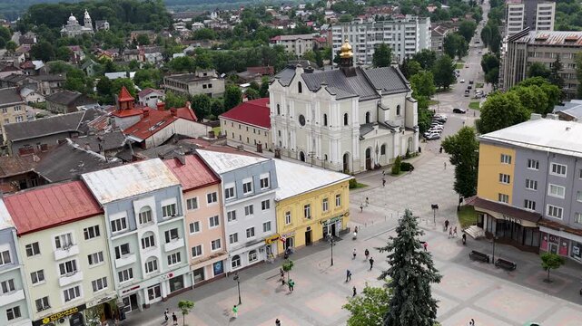 High angle stationary shot from the city hall tower overlooking historic colorful buildings and the pedestrian Rynok Square plaza in the old town of Drohobych, Ukraine.