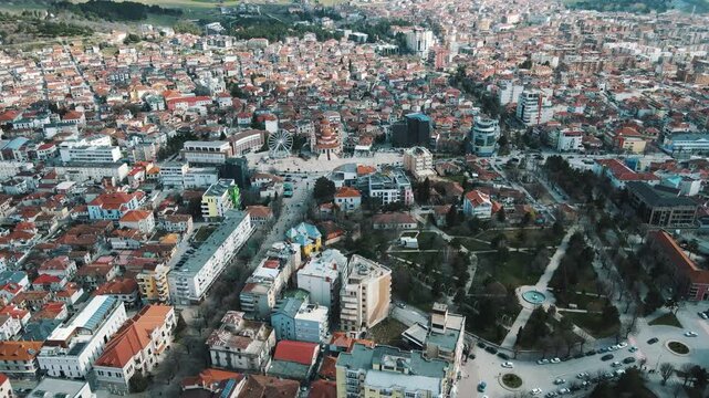 Aerial Drone Shot of Korca City Center with Ferris Wheel and Traditional Tiled Roofs