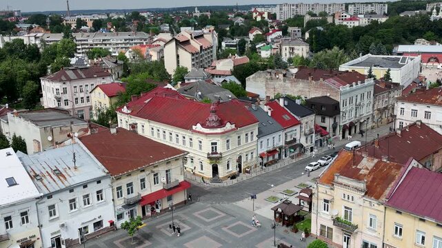High angle stationary shot from the city hall tower overlooking historic colorful buildings and the pedestrian Rynok Square plaza in the old town of Drohobych, Ukraine.