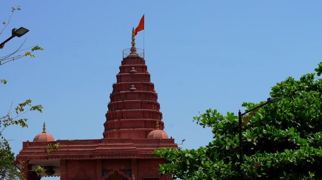 Temple Shikhara Rising Above Trees Under Clear Sky in Ujjain