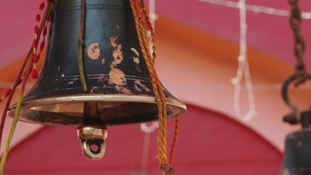 Close Up of Temple Bell Hanging During Hindu Worship Rituals