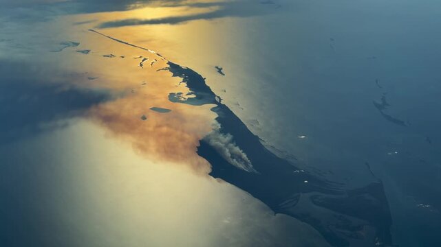 4k aerial video footage of a large bush fire on Little Abaco Island (June 2026), The Bahamas near Cedar Harbor with a large cloud of smoke is drifting westward during sunset 