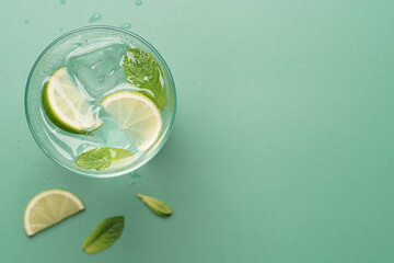 Fresh mojito ingredients with copy space on pastel green background © hannamartysheva