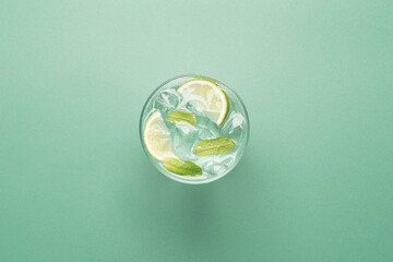 Minimal mojito cocktail with copy space on pastel green background © hannamartysheva