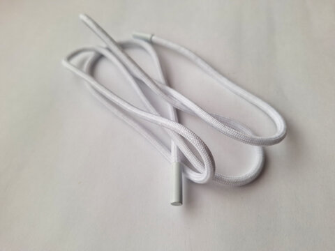 White shoelace with plastic aglets isolated on white background