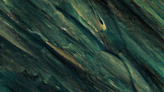 Abstract oil paint texture background with diagonal green and golden brushstrokes on canvas